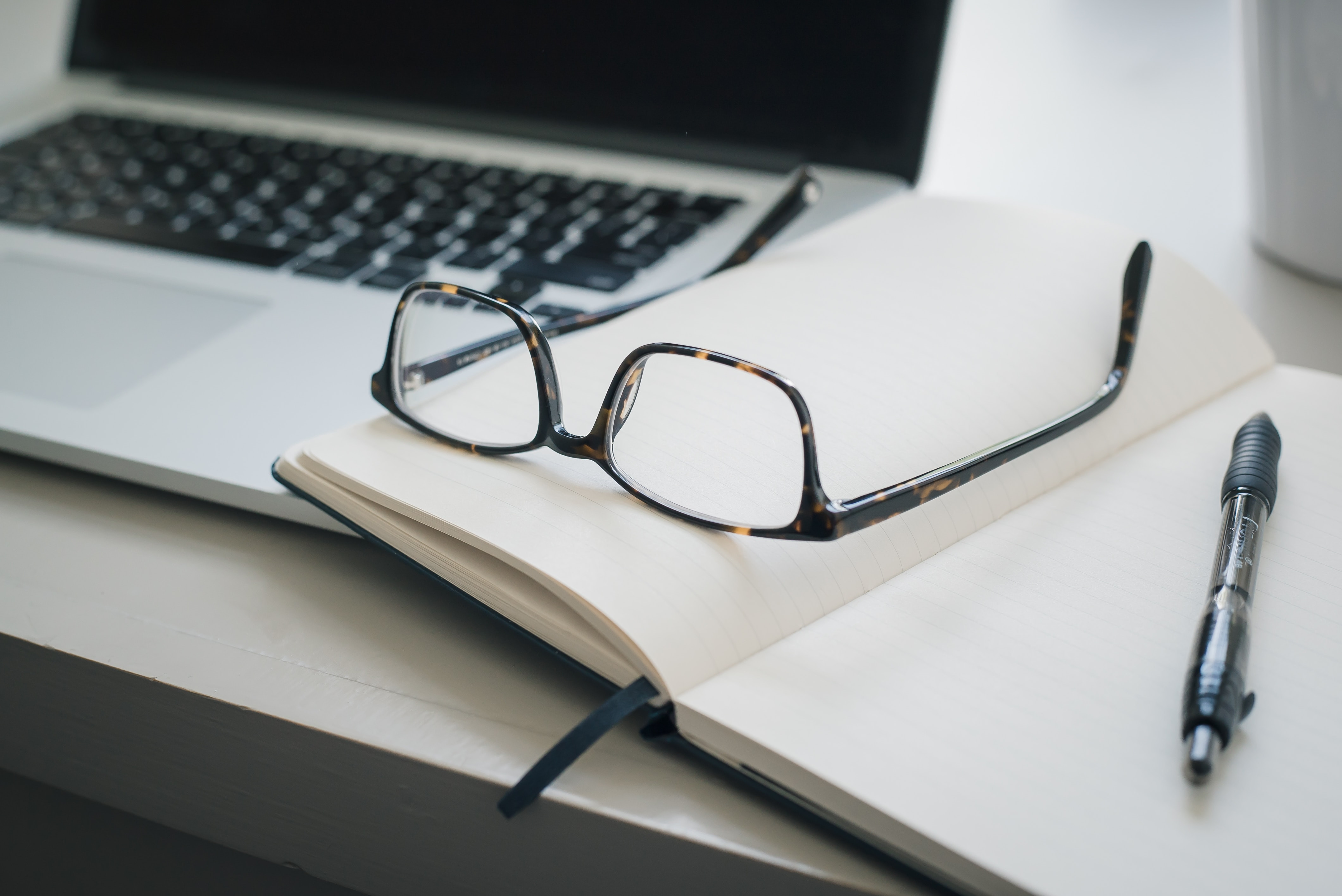 Eye glasses on open book on desk